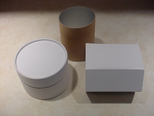 Two white boxes and one cardboard tube